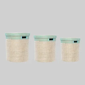 Handcrafted teal and natural straw laundry basket with a flat lid, ideal for laundry and stylish home storage.