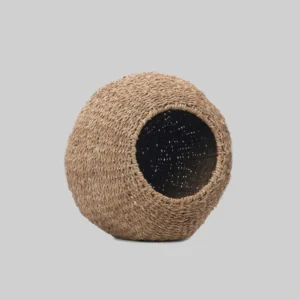 A handwoven dome-shaped seagrass pet basket with a wide circular entrance and soft removable cushion. A cosy hideaway for cats, small dogs and rabbits. Size: H 40 cm × Dia 45 cm.