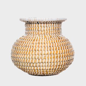 Handwoven natural seagrass tabletop vase with white woven accents, measuring 22 cm high and 23 cm wide, displayed with dried flowers and greenery in a warm neutral interior.